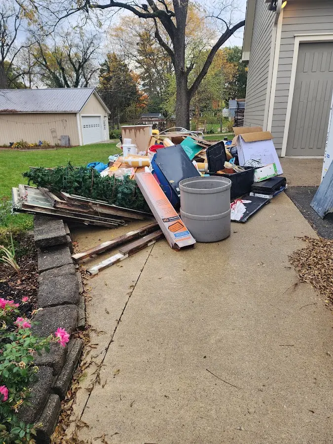 Dumpster being loaded with debris for Estate Cleanout Dumpster Rental in Tarrant